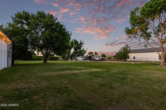a view of a field of grass and trees
