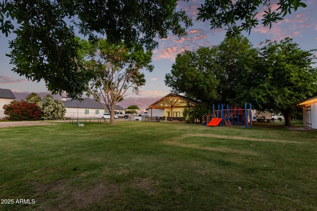 a view of building with garden and trees