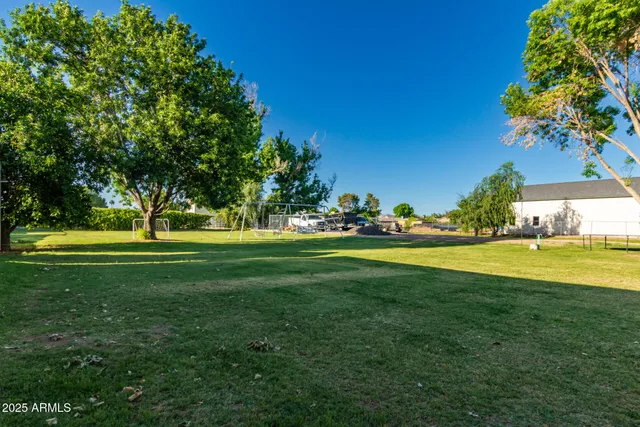 a view of a room that has a bed and a table in it