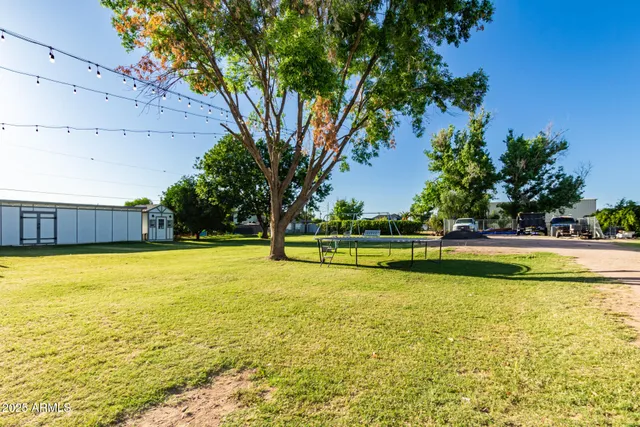 a view of an outdoor dining space with a table and chairs