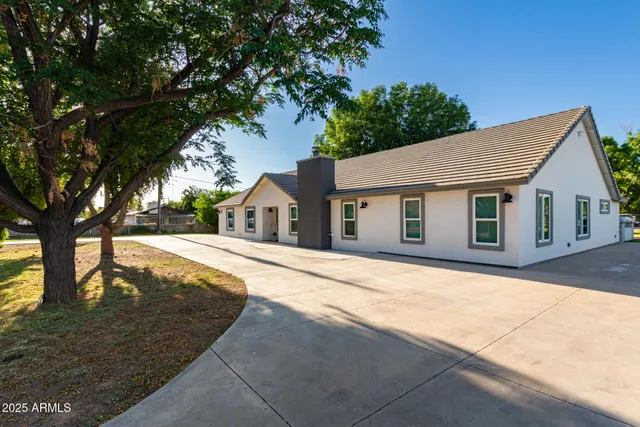 a living room with furniture and a view of kitchen