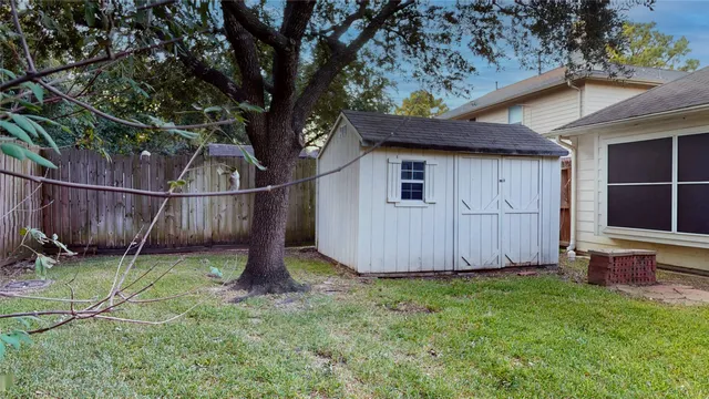 a view of a house with a small yard and wooden floor and a door