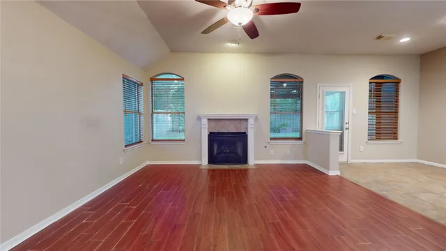 a view of a hallway with wooden floor and workspace