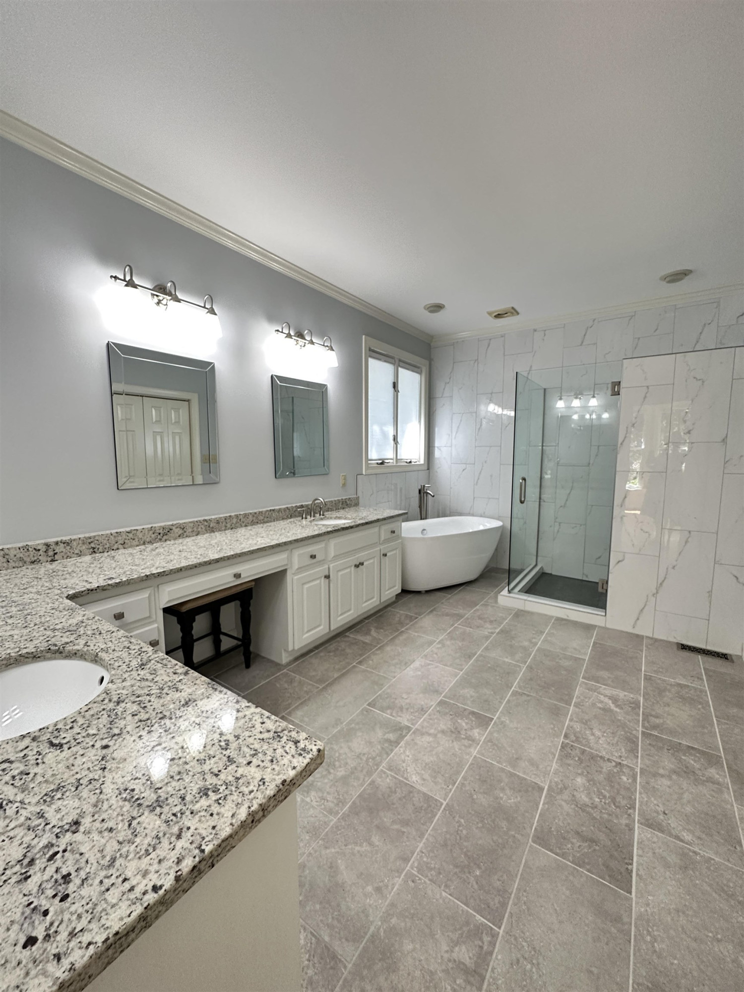 100 Grey Bridge Row Cary, NC 27513 - Photo 13 of 28 a large bathroom with a granite countertop sink and a mirror