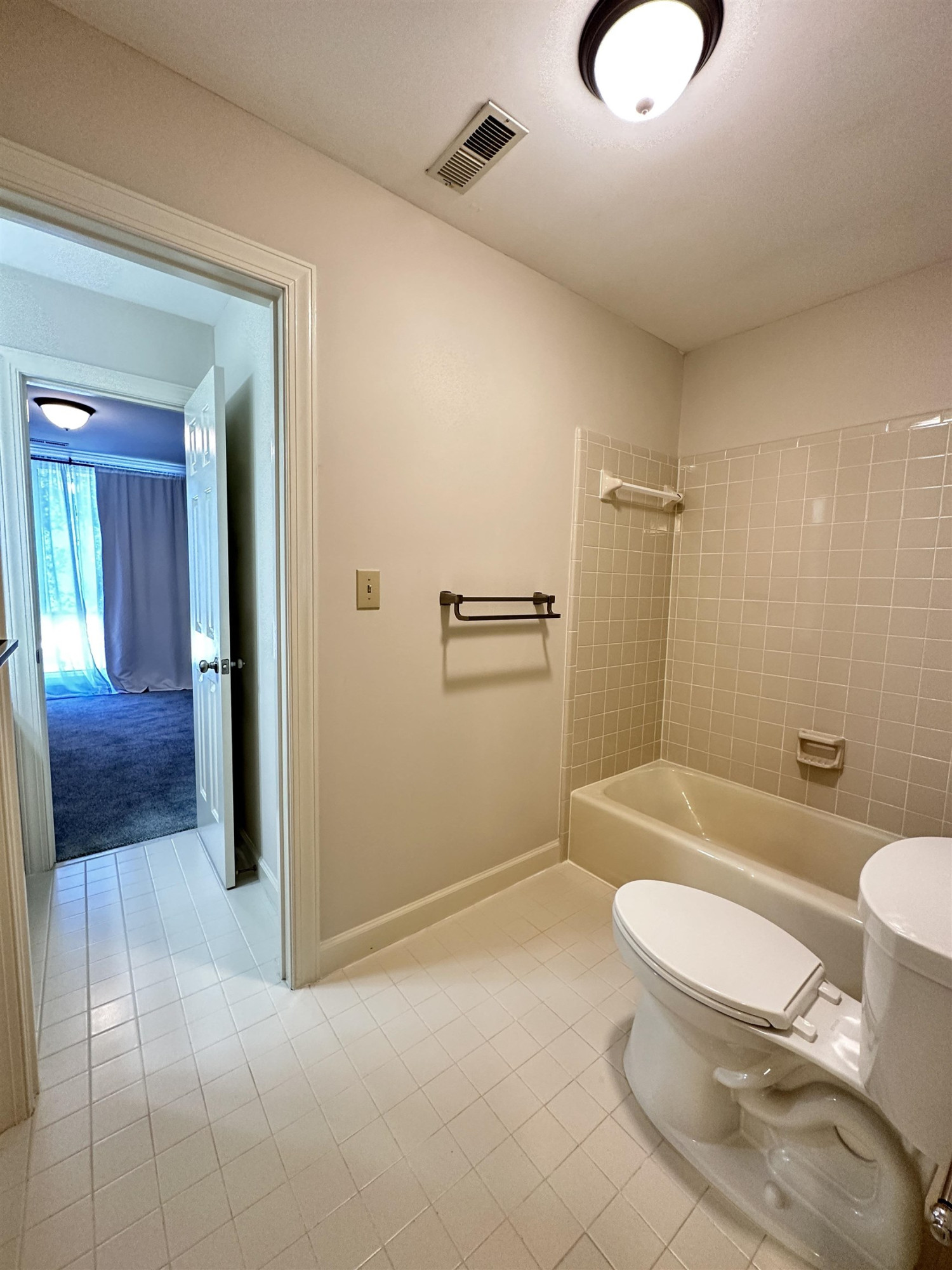 100 Grey Bridge Row Cary, NC 27513 - Photo 18 of 28 a bathroom with a granite countertop toilet a sink and bathtub