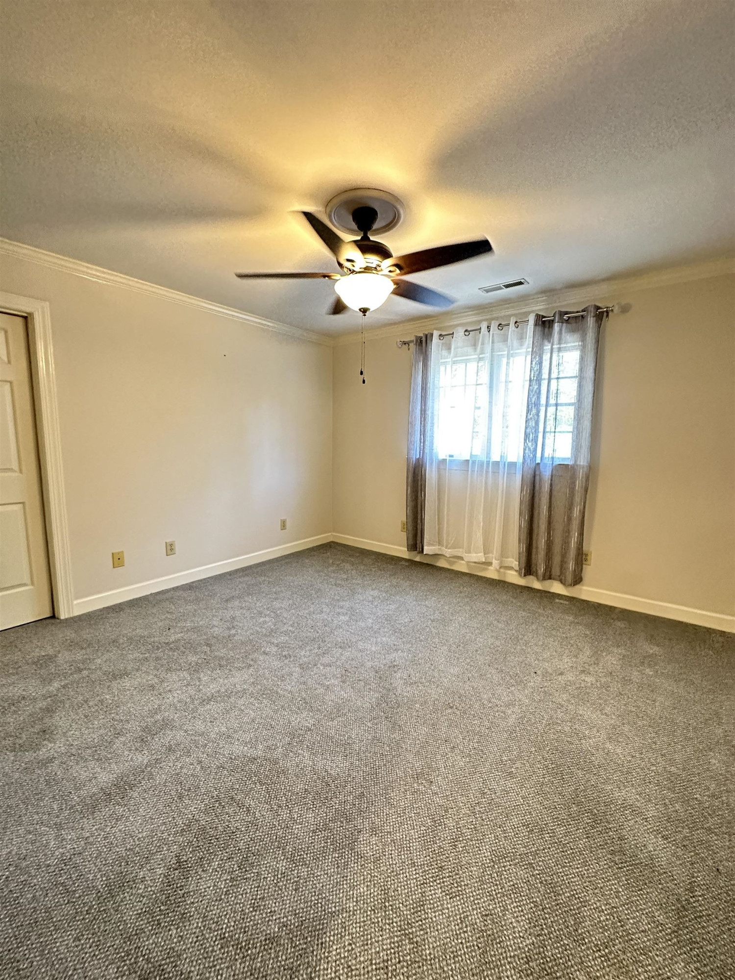 100 Grey Bridge Row Cary, NC 27513 - Photo 19 of 28 an empty room with a ceiling fan and window