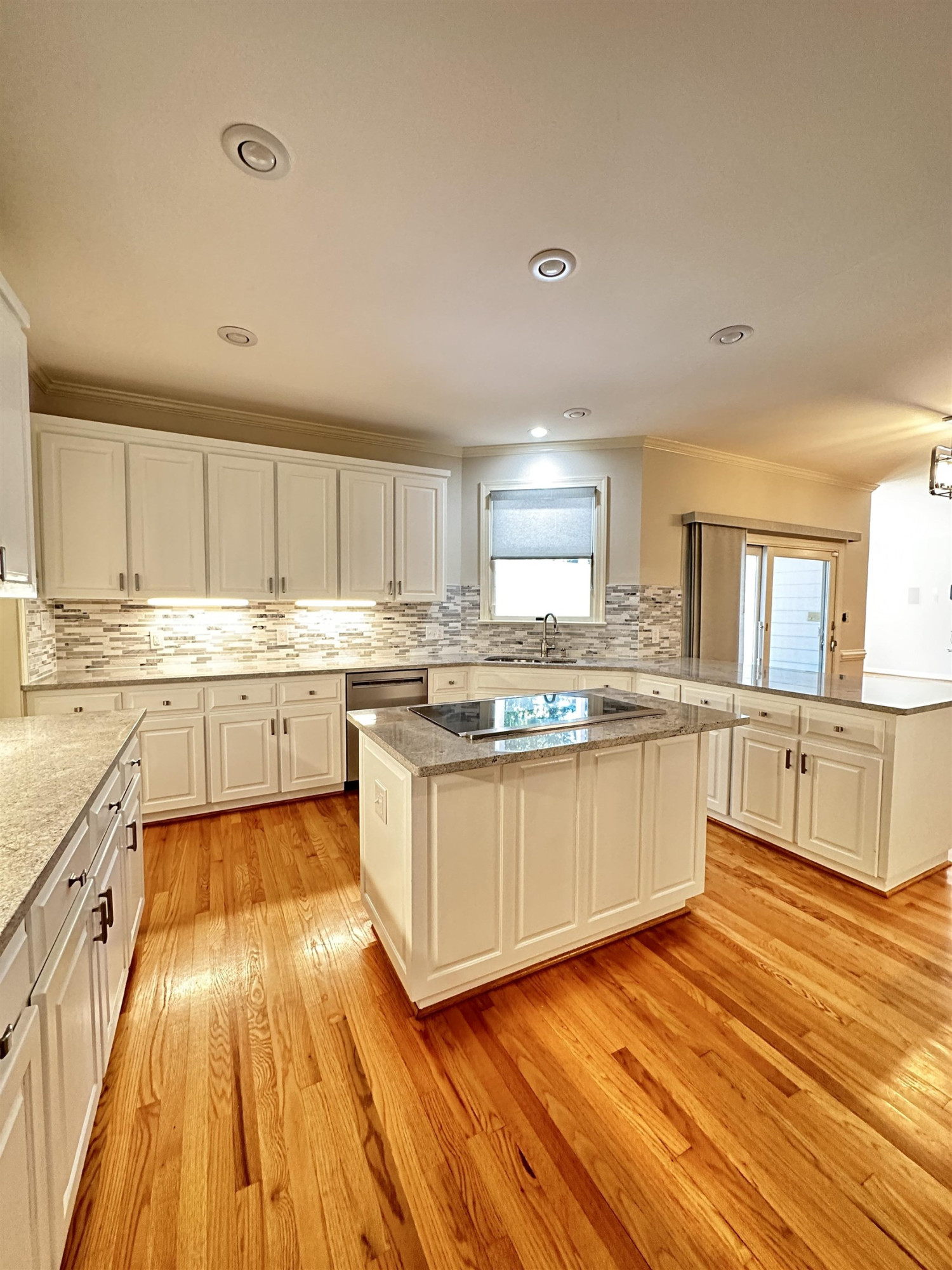 100 Grey Bridge Row Cary, NC 27513 - Photo 10 of 28 a large kitchen with cabinets counter space a sink and stainless steel appliances