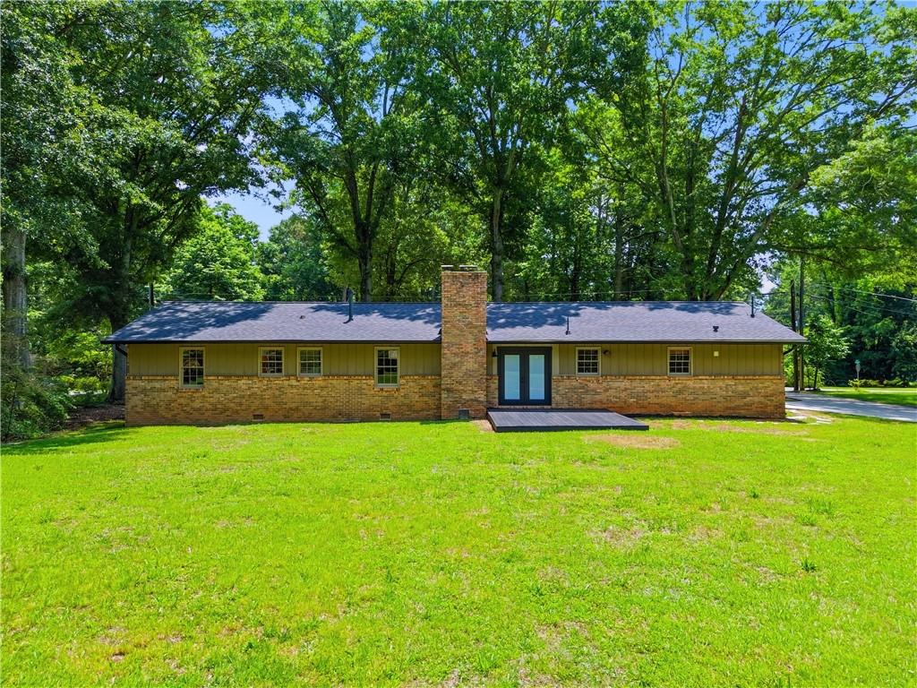 125 Childers Road Canton, GA 30115 - Photo 38 of 48 a front view of a house with yard and green space