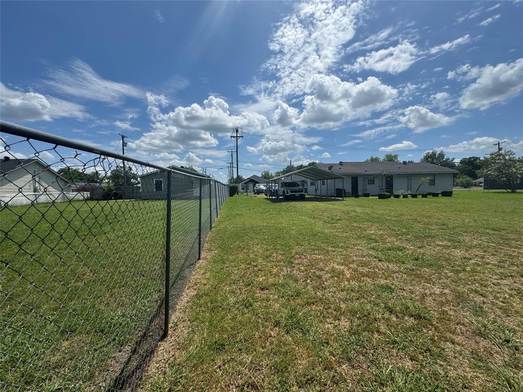207 College Mound Road Terrell, TX 75160 - Photo 12 of 14 Expansive property with a chain-link fence, a large grassy yard, and a single-story residence