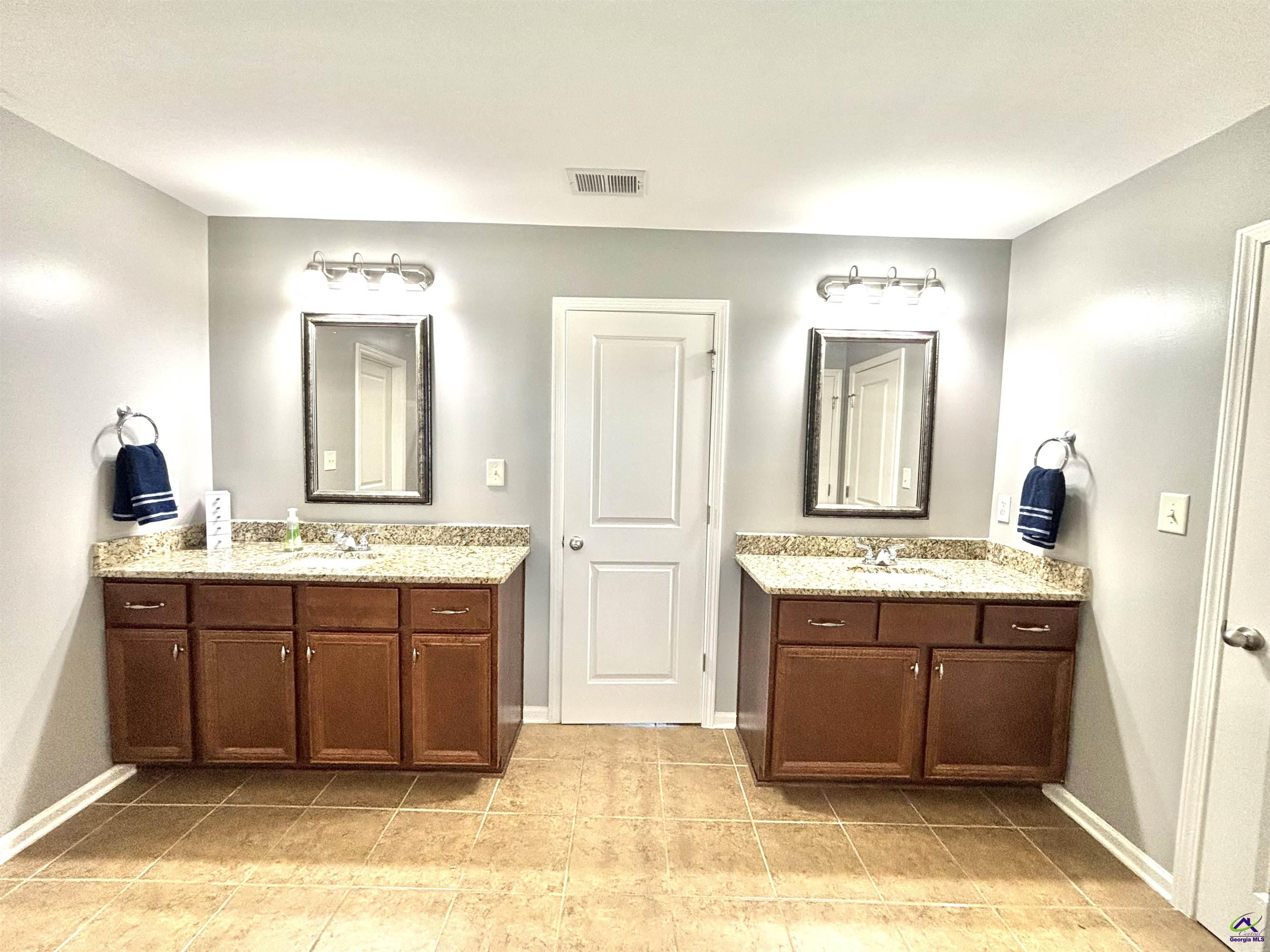 600 Post Oak Way Warner Robins, GA 31088 - Photo 34 of 50 a spacious bathroom with a granite countertop sink and a mirror