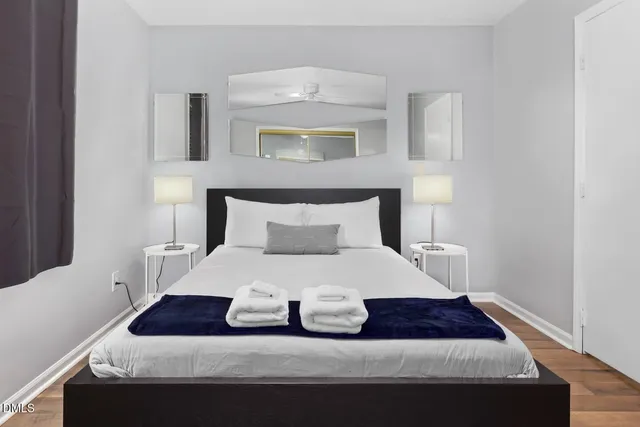 a bedroom with a bed and a night stand