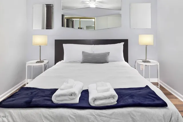 a large bed sitting in a bedroom next to a lamp