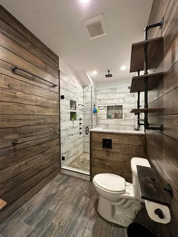 a bathroom with a toilet and a shower