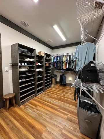 a room with lots of furniture and wooden floor