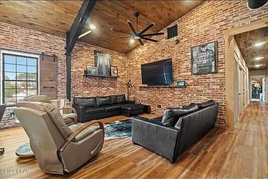 a outdoor living space with patio furniture and a flat screen tv