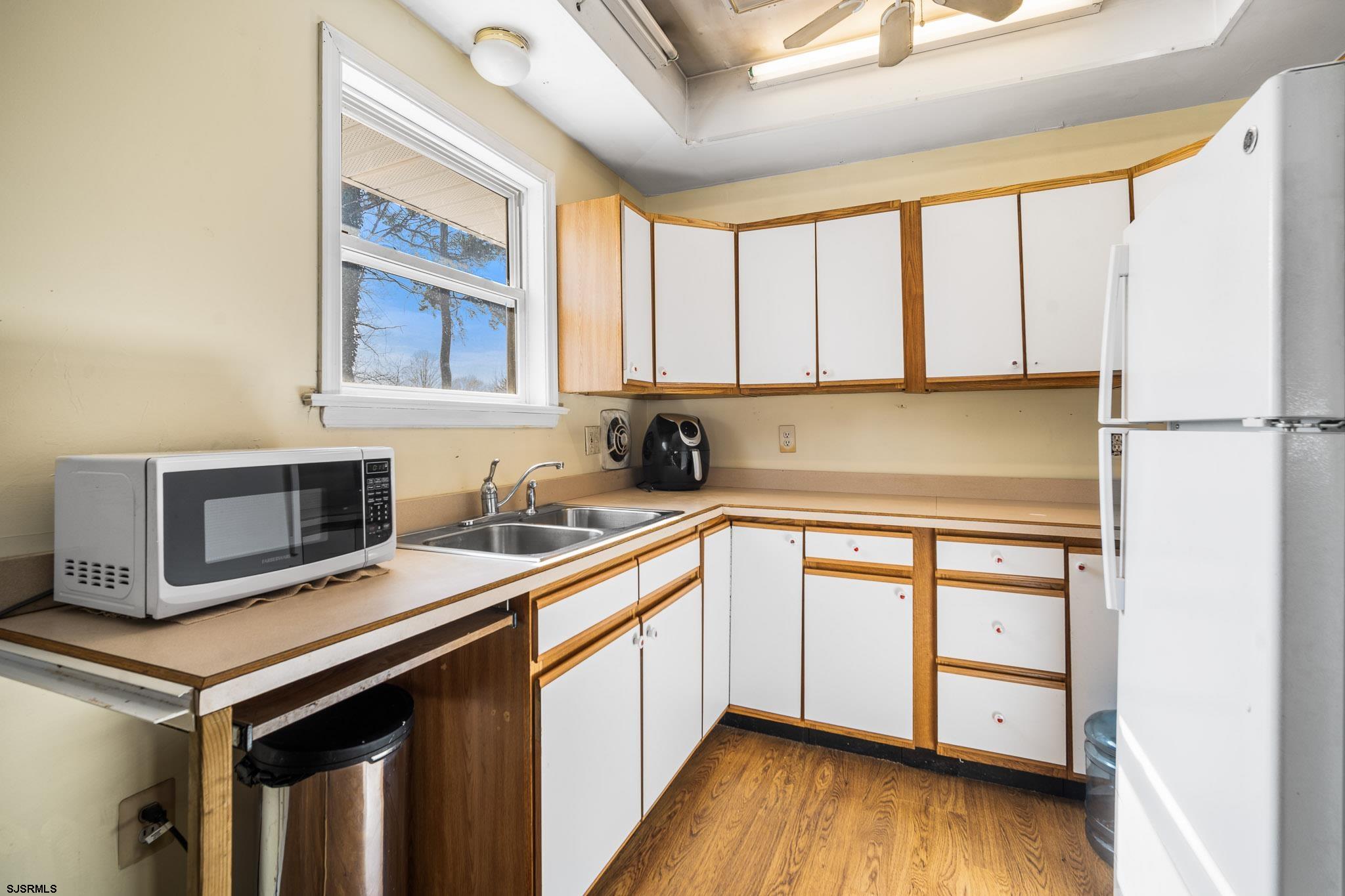 123 Bayview Drive Absecon, NJ 08201 - Photo 13 of 23 a kitchen with stainless steel appliances granite countertop a stove a sink and a microwave