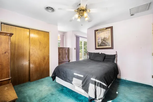 a bedroom with a large bed and a chandelier