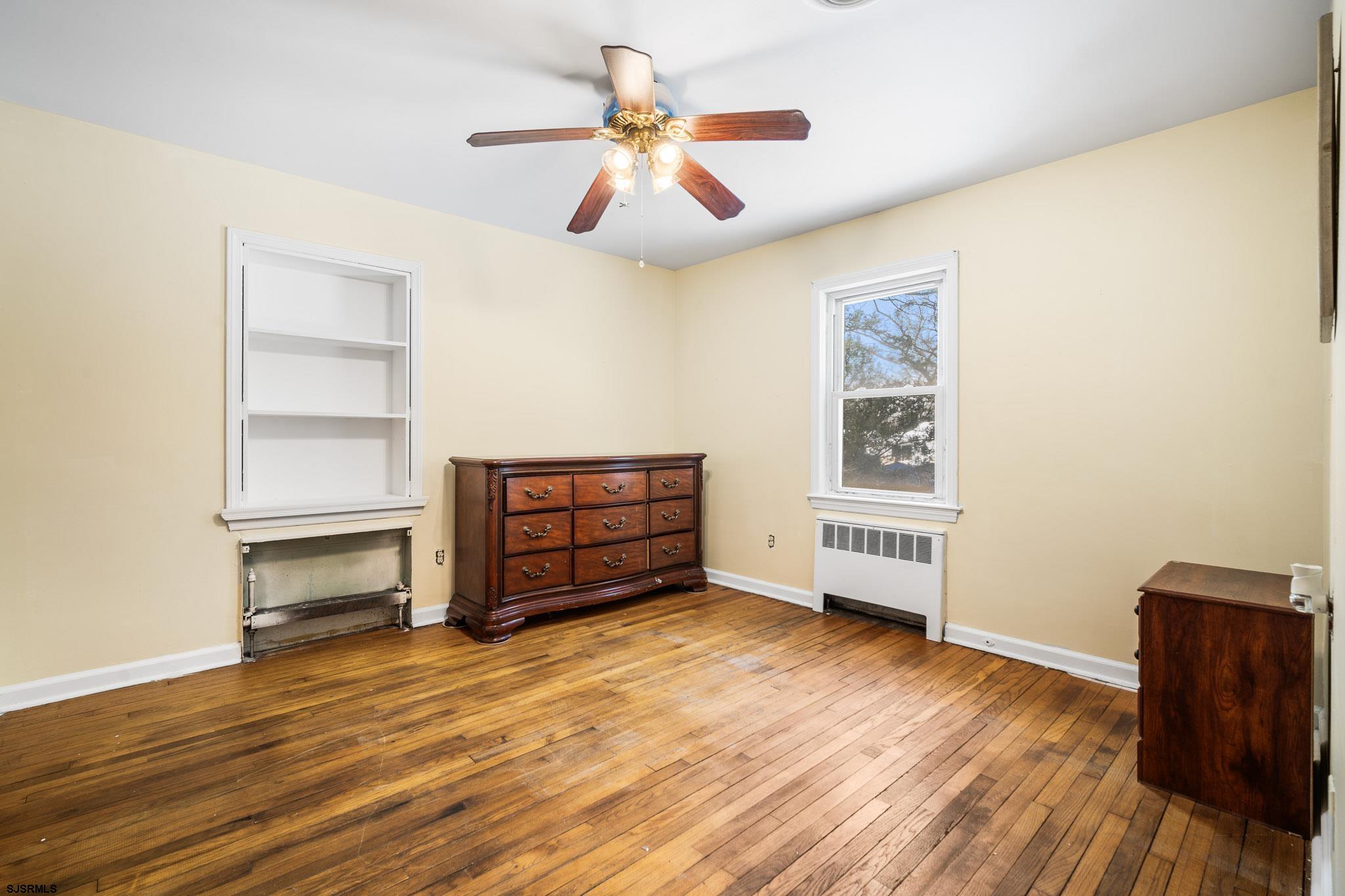 123 Bayview Drive Absecon, NJ 08201 - Photo 17 of 23 an empty room with wooden floor closet and windows