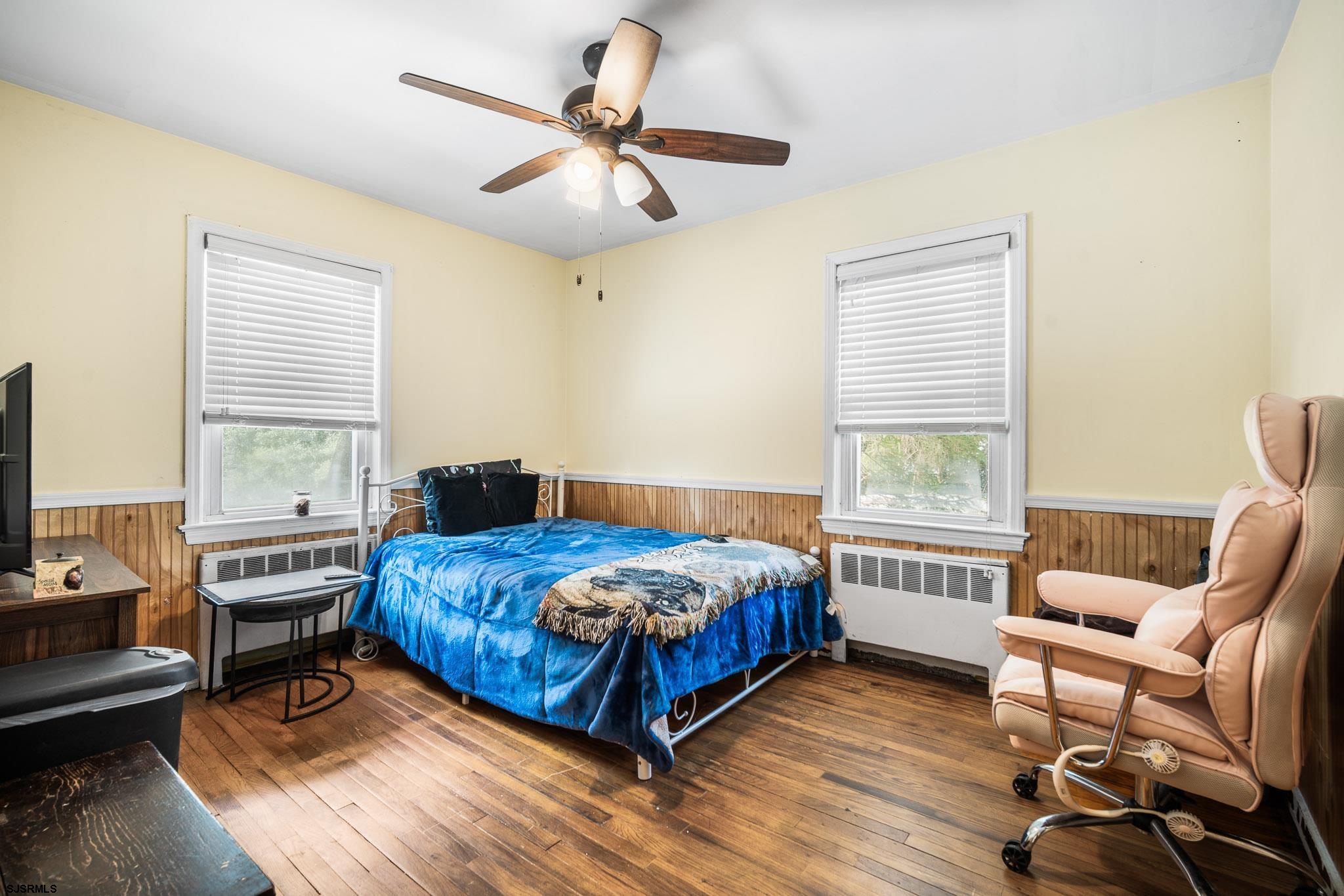 123 Bayview Drive Absecon, NJ 08201 - Photo 19 of 23 a bedroom with a bed a chair and a chandelier