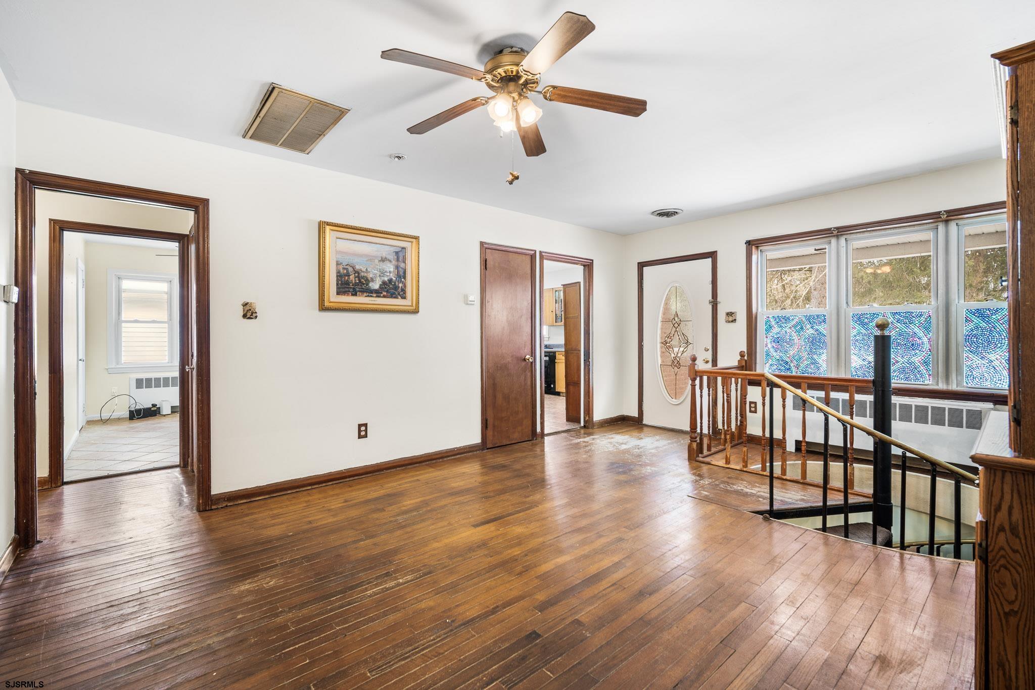 123 Bayview Drive Absecon, NJ 08201 - Photo 21 of 23 a view of a livingroom with furniture wooden floor and a ceiling fan