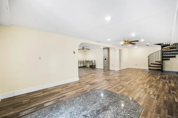 a view of a kitchen with a sink and a refrigerator