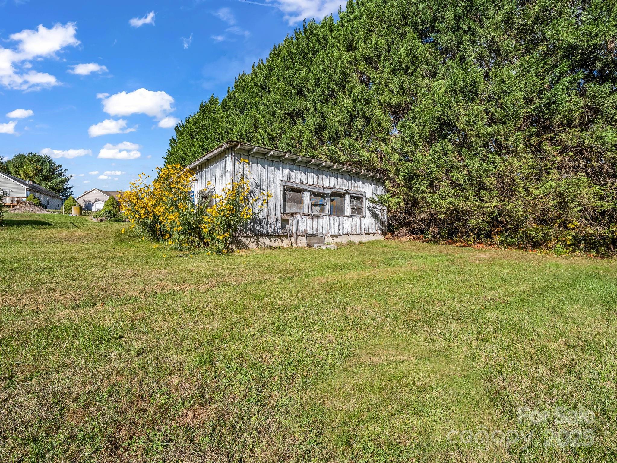 1600 Orchard Road Flat Rock, NC 28731 - Photo 23 of 33 a view of house with yard and trees in the background