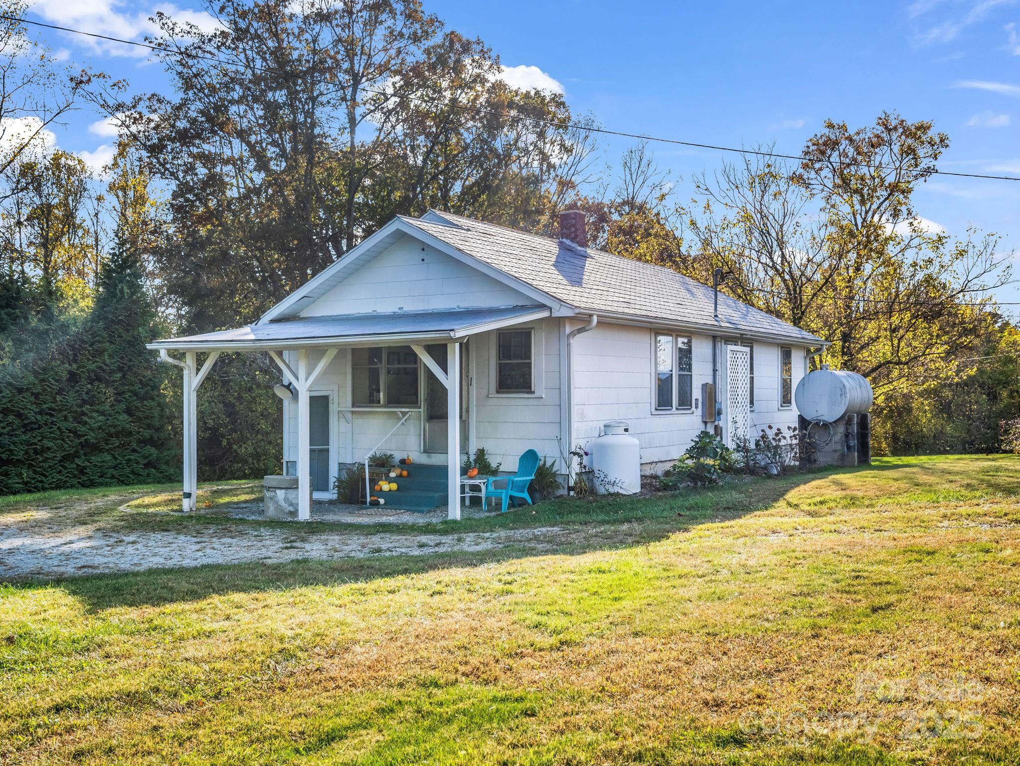 1600 Orchard Road Flat Rock, NC 28731 - Photo 30 of 33 a front view of a house with swimming pool and porch with furniture