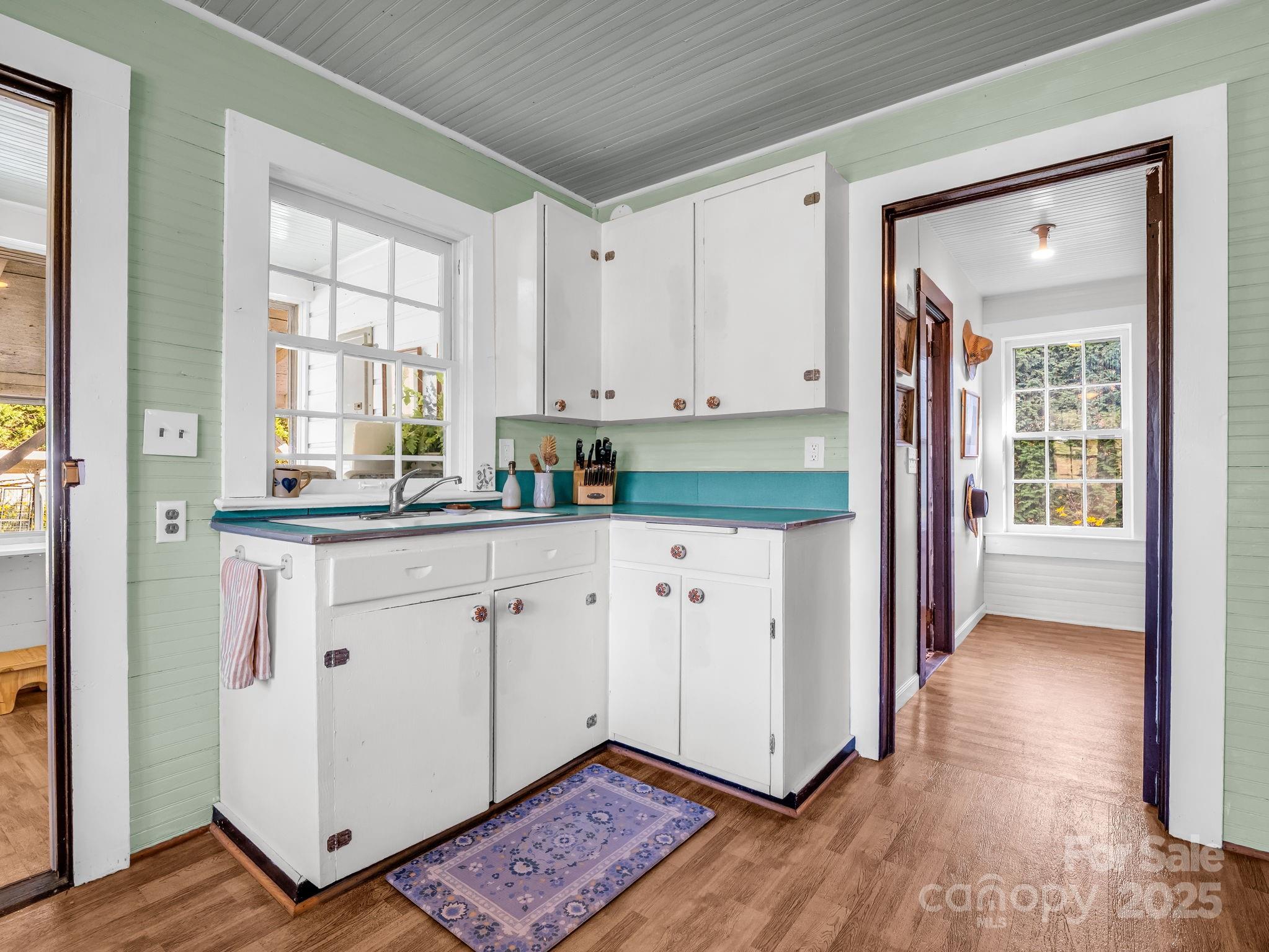 1600 Orchard Road Flat Rock, NC 28731 - Photo 8 of 33 a kitchen with granite countertop white cabinets and white appliances