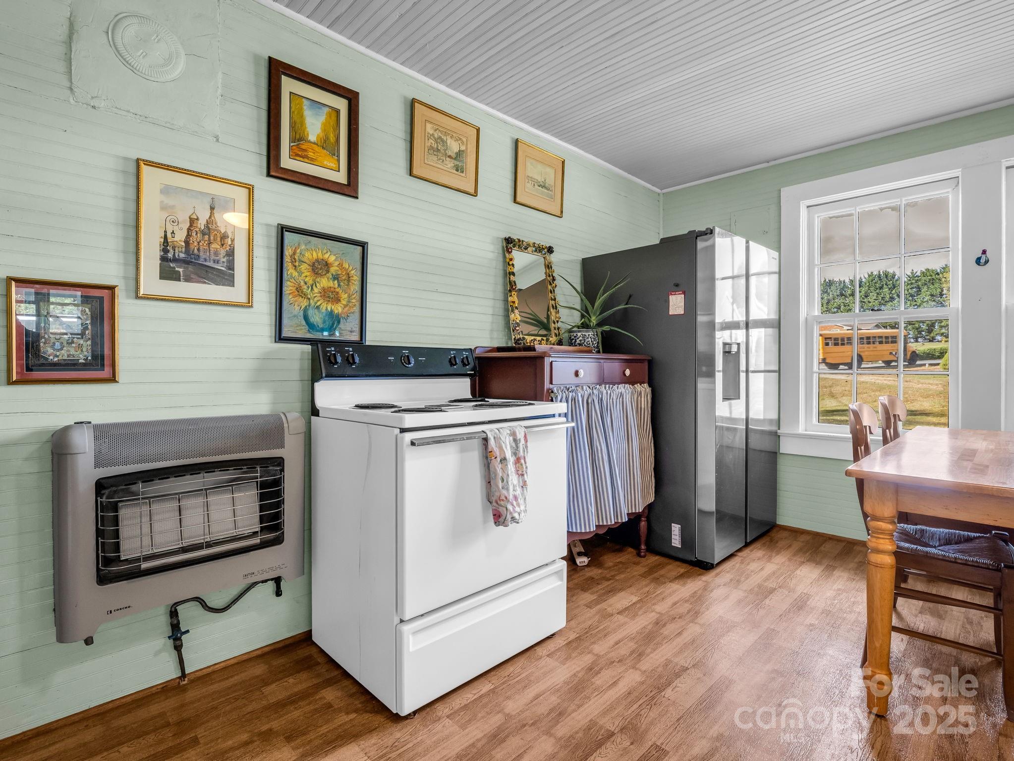 1600 Orchard Road Flat Rock, NC 28731 - Photo 9 of 33 a room with furniture a flat screen tv and a refrigerator