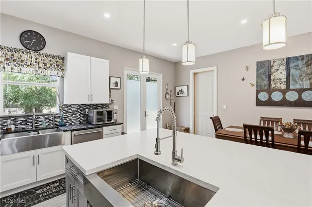 a kitchen with stainless steel appliances granite countertop a stove and a sink