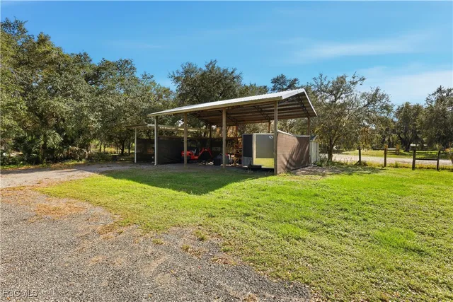 a view of a house with yard and tree s