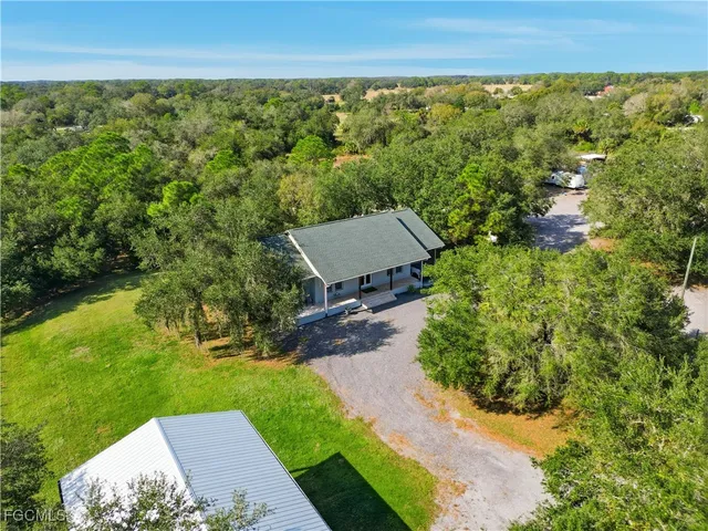 an aerial view of a house with a yard