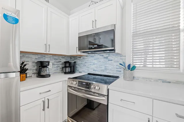 a kitchen with a sink cabinets and wooden floor