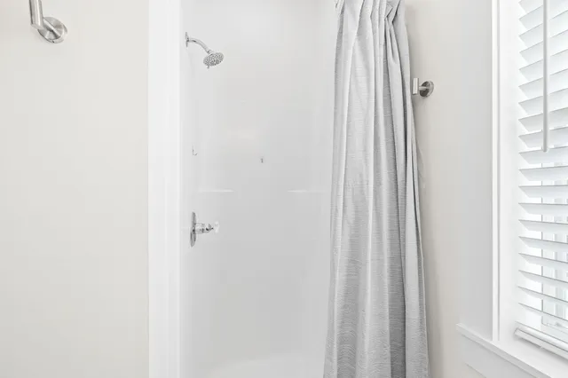 a bathroom with a sink mirror and toilet