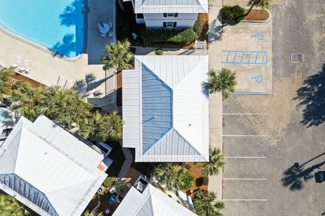 an aerial view of a house with garden space and swimming pool