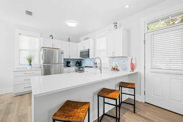 a kitchen with stainless steel appliances a refrigerator and a stove top oven