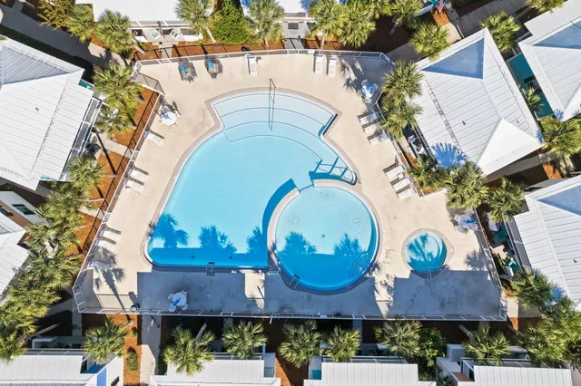 a view of a swimming pool with outdoor seating