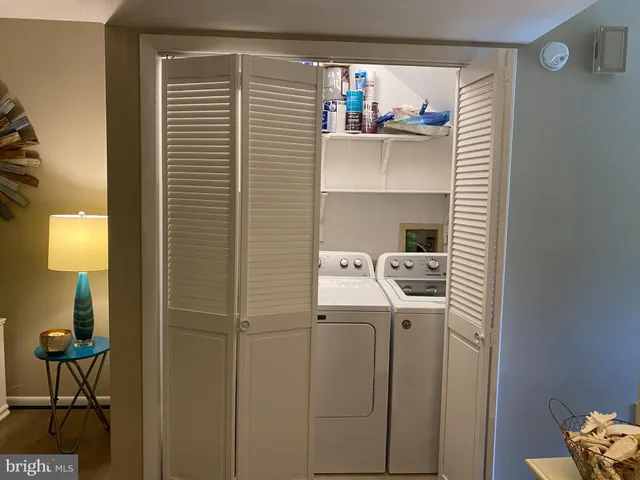 a kitchen with a refrigerator and table