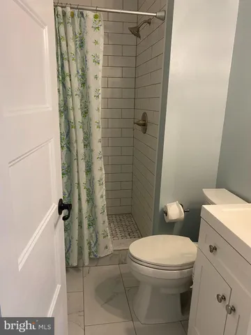 a white toilet sitting next to a bathroom sink