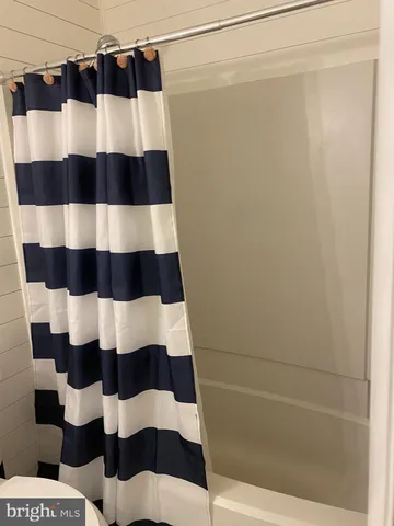 a bathroom with a black and white checkered floor
