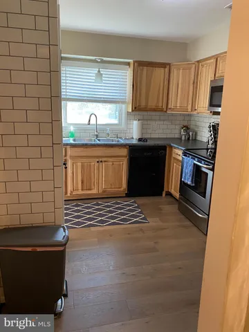 a kitchen with a sink and a stove top oven