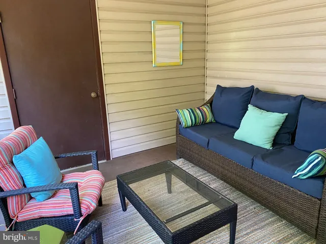 a outdoor sitting area with furniture and wooden floor