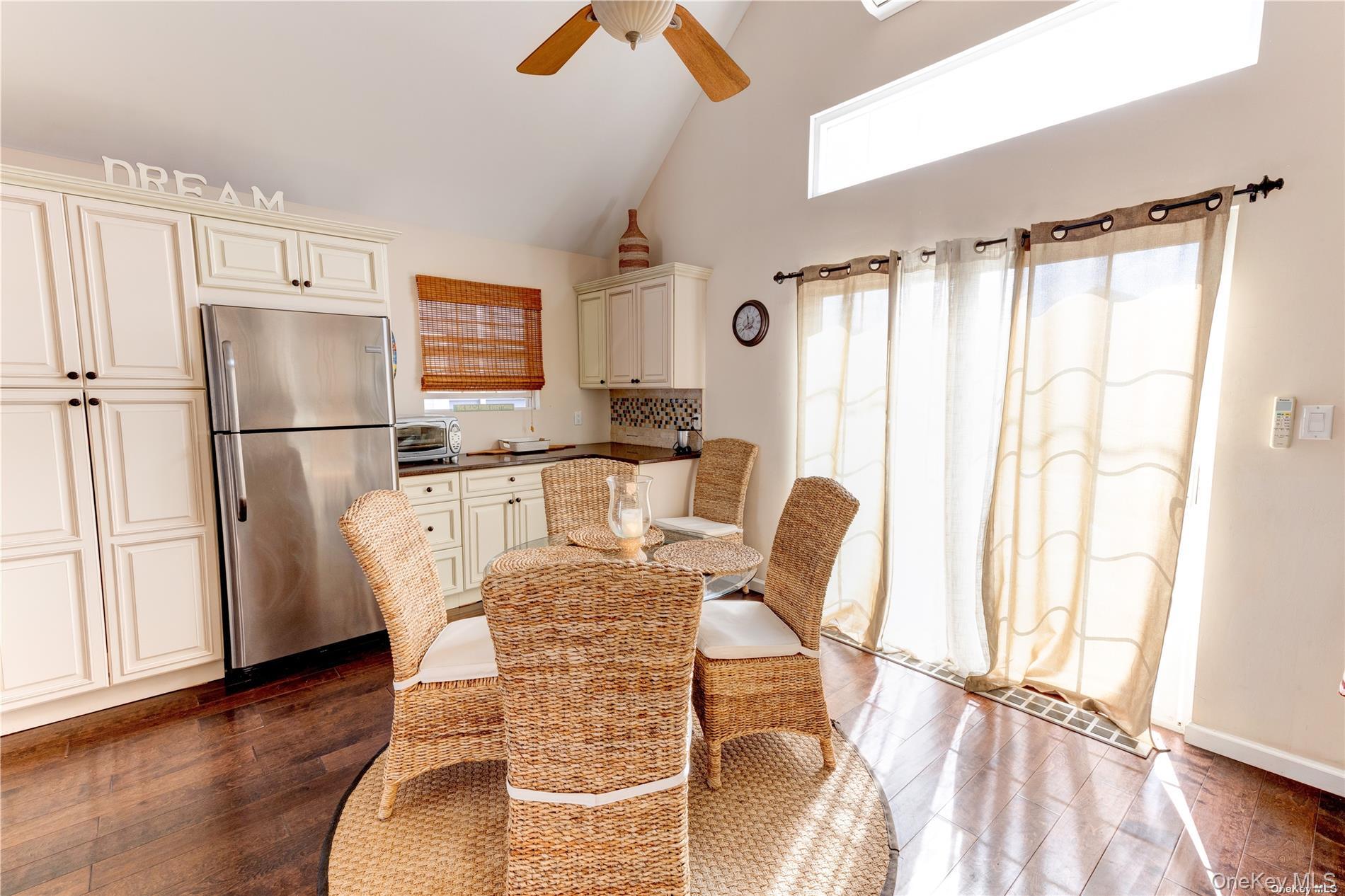 67 Vermont Street Long Beach, NY 11561 - Photo 13 of 26 a kitchen with granite countertop a refrigerator a stove a sink cabinetry and a dining table