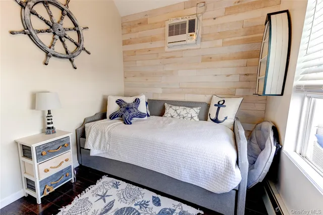 a bedroom with bed and wooden floor