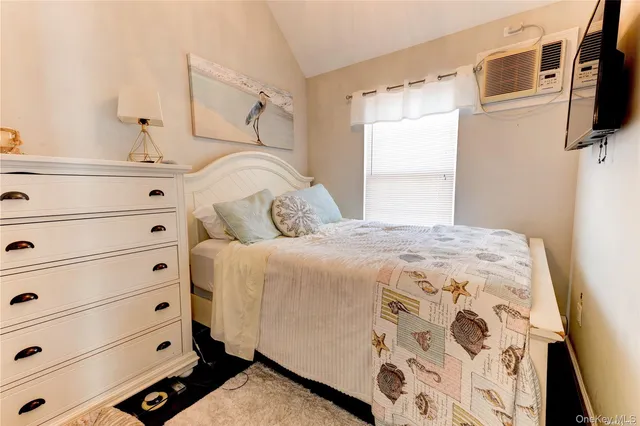 a bedroom with a bed and flat screen tv