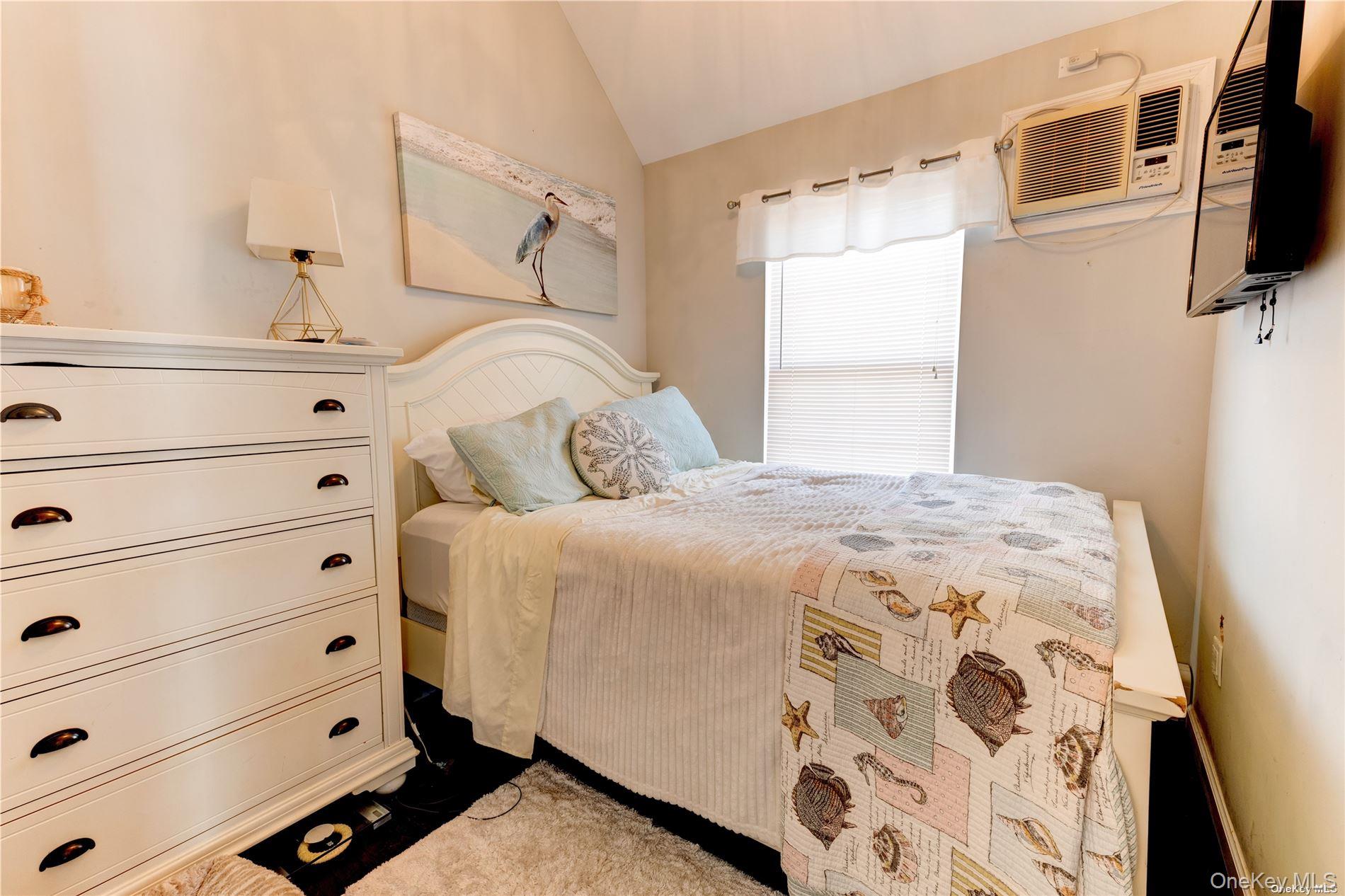 67 Vermont Street Long Beach, NY 11561 - Photo 22 of 26 a bedroom with a bed and flat screen tv