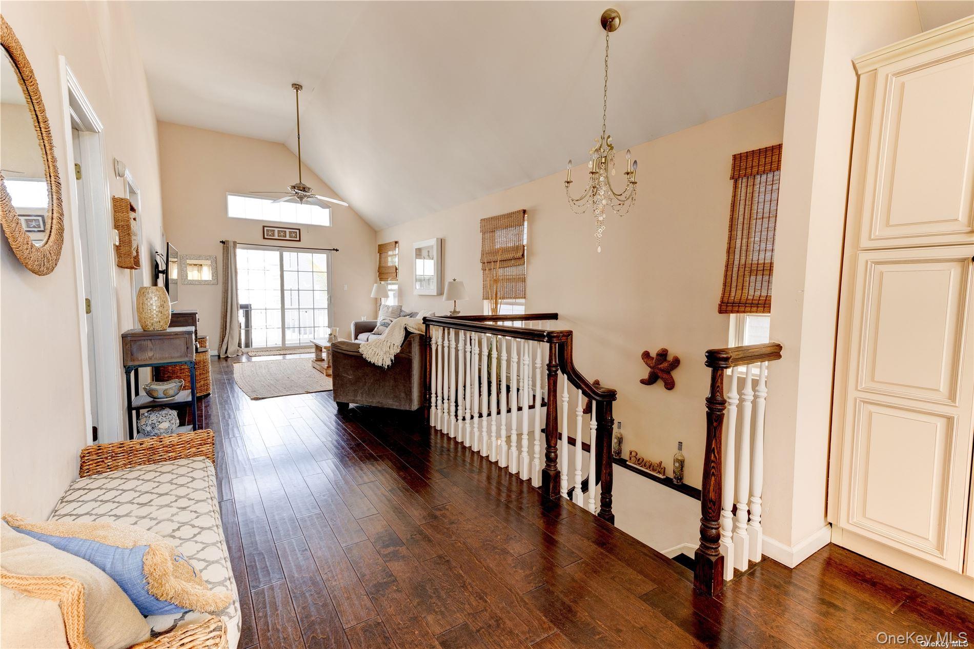 67 Vermont Street Long Beach, NY 11561 - Photo 23 of 26 a view of a livingroom with furniture stairs wooden floor and windows