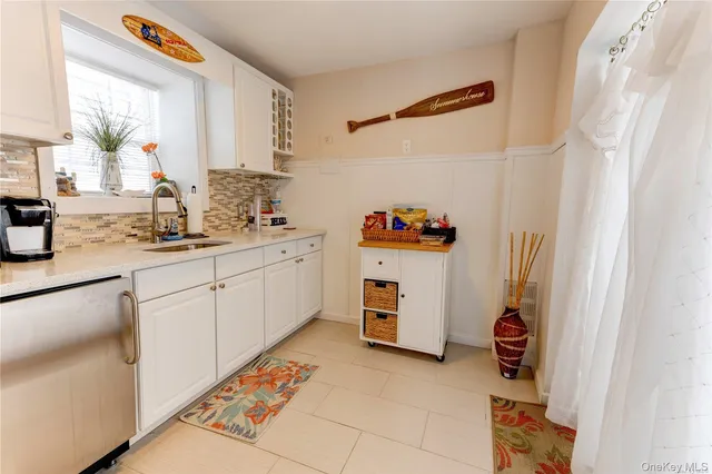 a kitchen with a sink appliances and cabinets