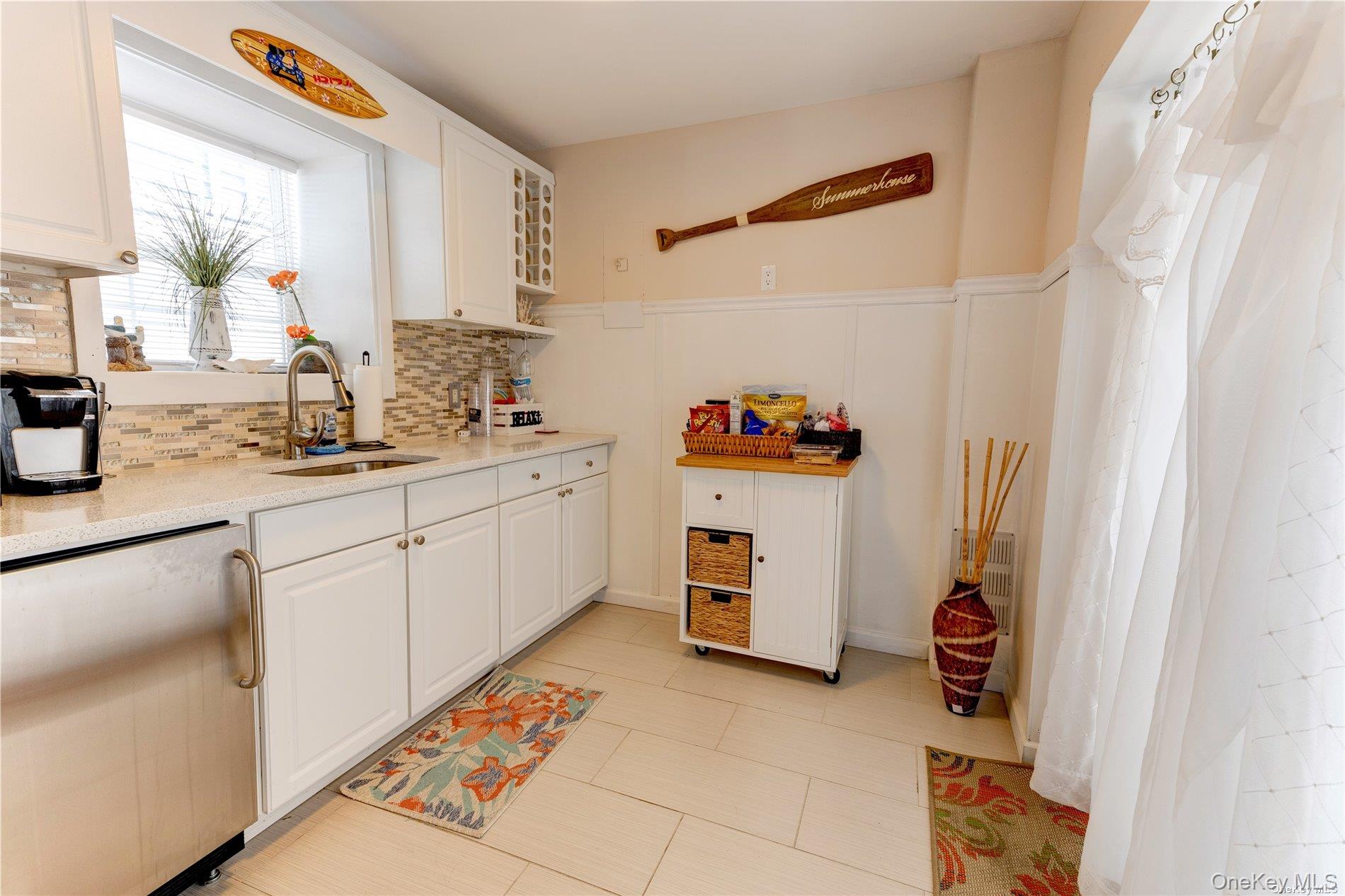 67 Vermont Street Long Beach, NY 11561 - Photo 25 of 26 a kitchen with a sink appliances and cabinets