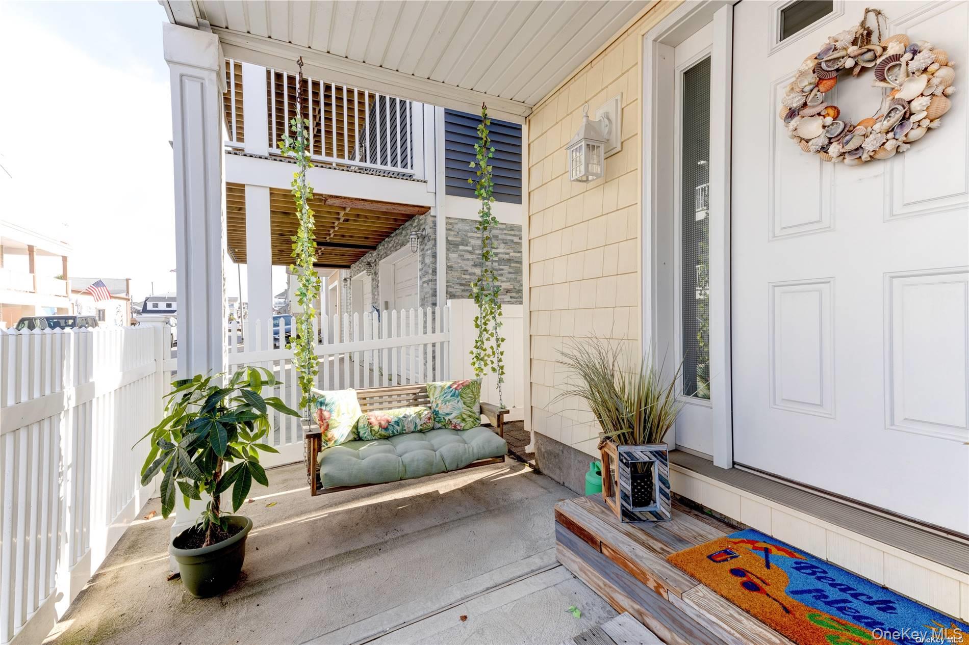 67 Vermont Street Long Beach, NY 11561 - Photo 3 of 26 a living room filled with furniture and a potted plant